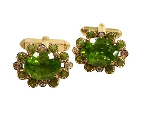 A pair of peridot and CZ cufflinks, the oval cut peridots, in a surround of pairs of brilliant cut peridots interspersed with
