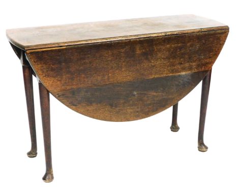 A George III oak drop leaf dining table, raised on turned legs and club feet, 74cm high, 116cm wide, 41cm eep, 126cm extended