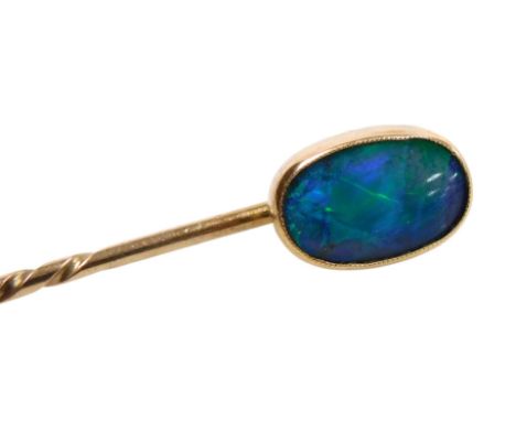 An opal doublet tie pin, of oval, polished form, in yellow metal, 2.0g.