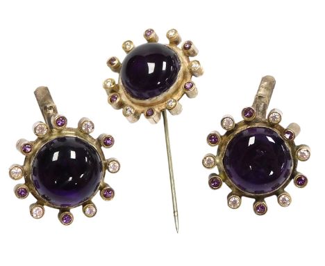 An amethyst and CZ set tie pin and pair of cufflinks, with central cabochons in a circular mount with alternating brilliant c