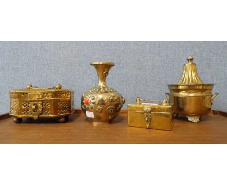A Victorian brass orange squeezer, a pierced brass casket and two others 