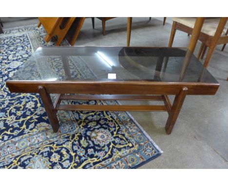 A teak and glass topped rectangular coffee table 
