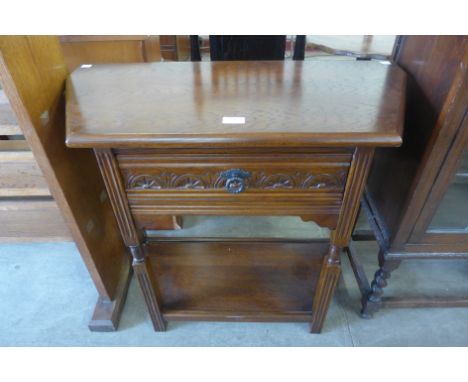 A carved oak single drawer credence table 