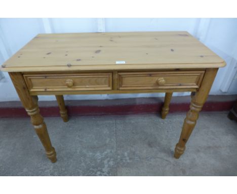 A pine two drawer kitchen table 