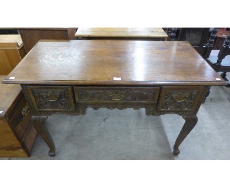 A 17th Century and later carved oak three drawer side table 