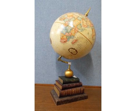 A desk top terrestrial globe, on faux book stand 