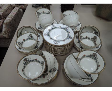 A Royal Worcester 36 piece tea service having gilt heightened Art Nouveau crossover decoration