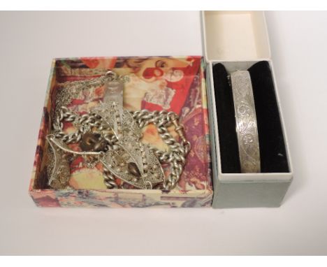 A selection of HM silver and white metal jewellery including a hinged bangle, ingot pendant, filigree bracelet, curb chain ne