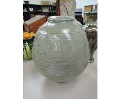 An art pottery vase of bulbous design by Leach Pottery having sgraffito decoration and impressed seal and script B.L. For Ber