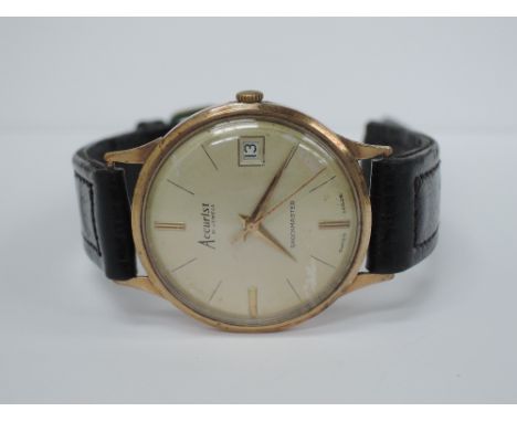 A gents yellow metal wrist watch by Accurist having baton numerals and date aperture, on a leather strap,  no marks