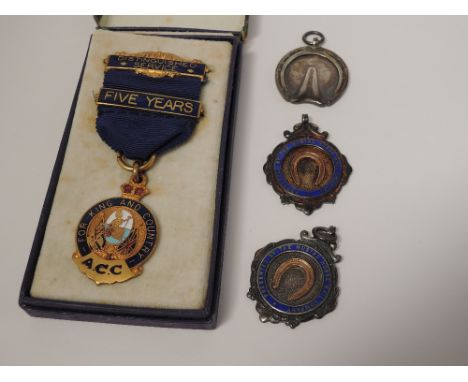 Two HM silver and enamel medals presented by the Mustad Horse Nail Co, another HM silver medal modelled as an equine hoof pre