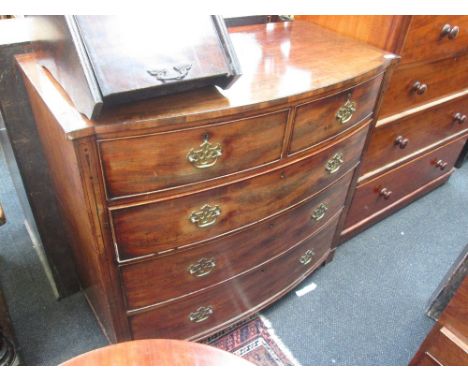 A 19th century mahogany bow front chest of 2 short and 3 long cockbeaded drawers on shaped feet