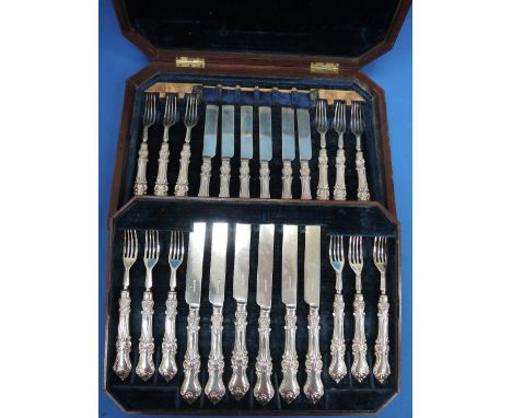 A Victorian canteen of 12 pairs of silver dessert knives and forks having scroll moulded decoration to handles, Sheffield 185