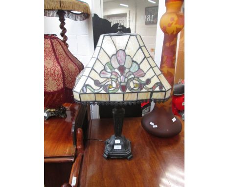 A modern Tiffany inspired table lamp having decorative shade and similar ceiling light