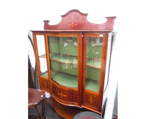 An Edwardian mahogany display cabinet having shaped crest and bow front with extensive line and foliate inlay decoration on t