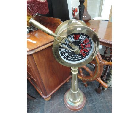 A traditional style brass ships engine room telegraph on circular wooden plinth
CONDITION REPORT, This lot is possibly reprod