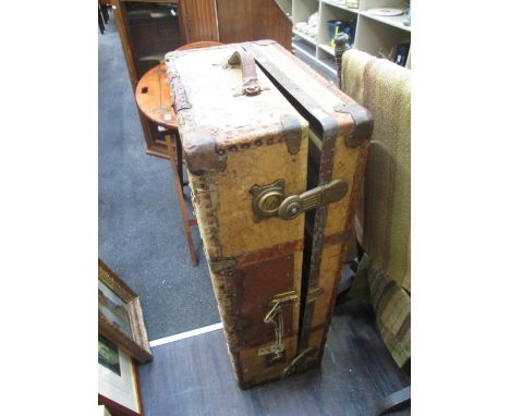 A vintage travel trunk having paper labels of rail interest