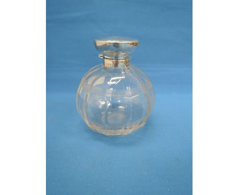 A glass perfume bottle of facetted spherical form having a silver collar and lid with engine turned decoration, Birmingham 19