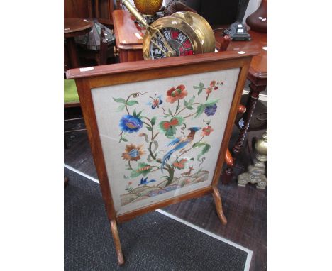 An early 20th century mahogany frame firescreen having crewel work floral inset