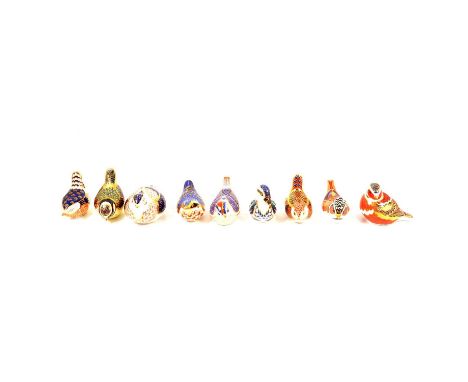 Nine Royal Crown Derby bird paperweights, to include Crested Tit, seven sided gold stopper; Nuthatch, gold stopper; Teal Duck