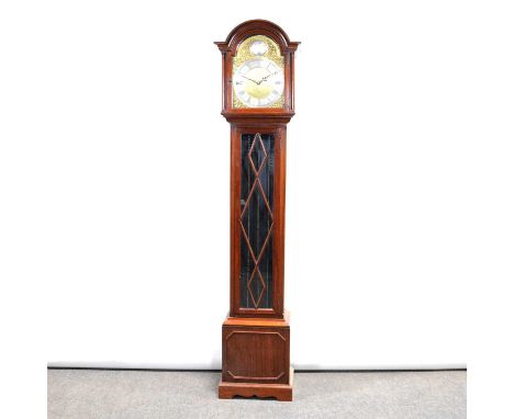 Modern mahogany longcase clock, case with domed top, long glazed door, bracket feet, ten inch arched brass dial, eight-day mo