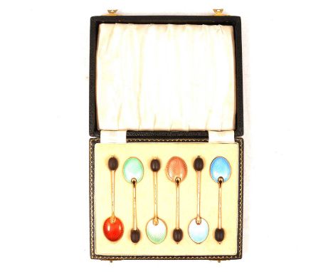 A set of six silver gilt and enamel coffee spoons, William Suckling Ltd, Birmingham 1955, bean terminals, cased.Condition rep