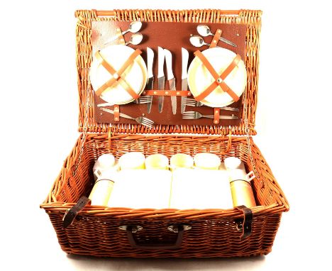 A vintage fitted cane picnic basket, and an embossed leather stick stand, stamped Finnigan's Manchester, 39.5cm.