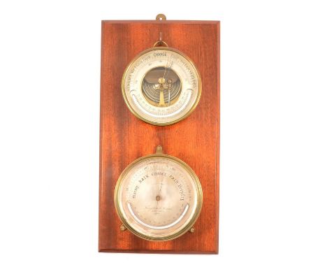 Troughton & Simms, London - a maritime-type brass drum case aneroid barometer, silvered chart, with thermometer; together wit