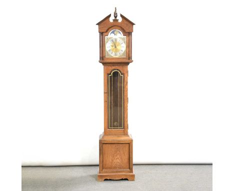 Modern oak longcase clock, architectural pediment with urn finial, long glazed door, bracket feet, 9.5" arched brass dial, th