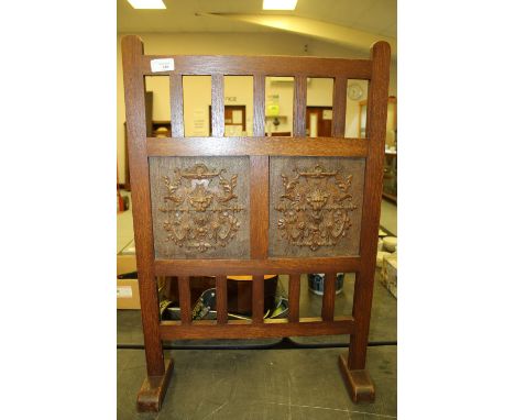 Arts &amp; Crafts oak fire screen with carved lion head masks