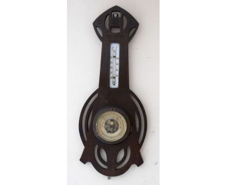 An Arts and Crafts period barometer with Glasgow School style design, geometric parts, the ceramic dial having lettering to t