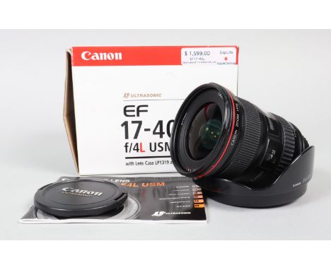 A Canon EF 17-40mm F/4 L USM Lens, serial no 393548, auto focus working, barrel G-VG, light wear, elements VG, with front/rea