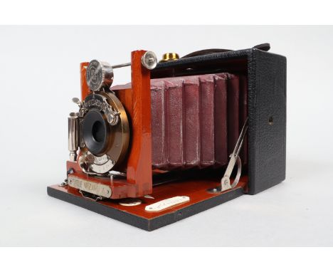 A Manhattan Cycle Wizard A Folding Plate Camera, quarter-plate, circa 1900, body G, retailer's plate states 'SOLD BY R.H. McB