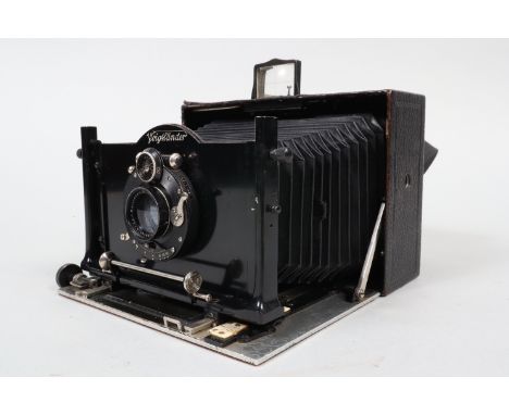 A Voigtländer Alpin 10 x 15cm Folding Plate Camera, circa 1910, fitted with movable internal stereo septum, body G, Compound 