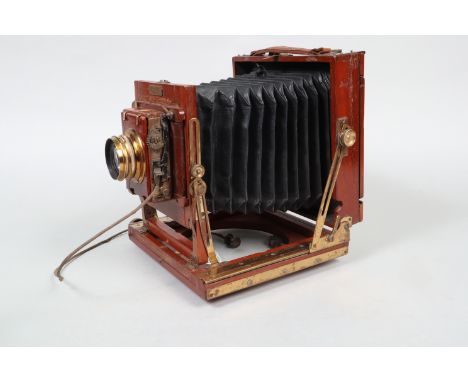 A Houghtons Ensign 'The Victo' Half-Plate Mahogany Field Camera,  circa 1905, triple extension, black chamfered bellows, body