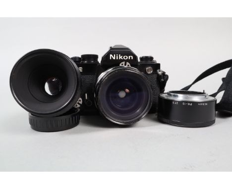 A Nikon FM2 Camera, black, serial no 7129168, shutter working, meter responsive, body G, some white powder deposits around mi