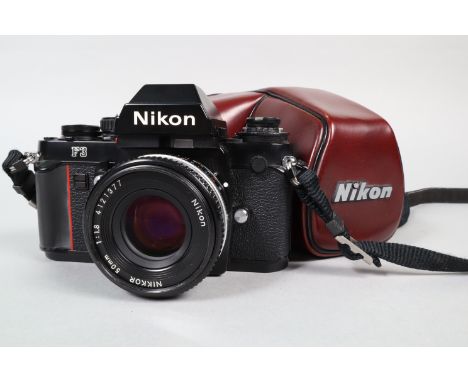 A Nikon F3 Camera, black, serial no 1947489, shutter working, meter responsive, body G-VG, light marks, with Nikkor 50mm f/1.