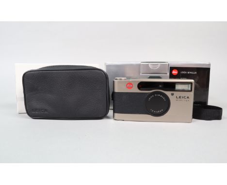 A Leica Minilux Compact Camera, serial no 2152212, powers up, shutter working, flash working, appears to function as should, 