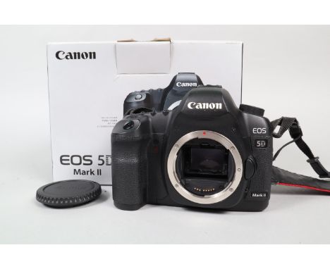 A Canon EOS 5D MkII DSLR Camera Body, serial no 0430201882, powers up, appears to function as should, body G, light wear, wit
