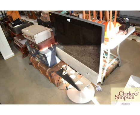 A Bang &amp; Olufsen television with remote control and instruction manual 