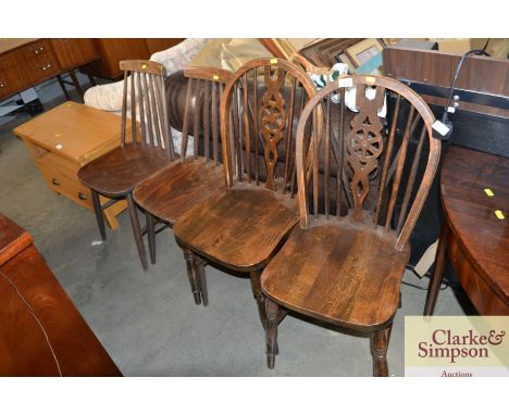 A pair of stick and wheel back dining chairs and a pair of stick back dining chairs