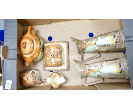 A collection of ceramic figures including Keele Street pottery cottage themed kitchen ware, two Radford embossed water jugs