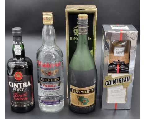 A 1 litre bottle of Remy Martin VSOP Cognac, (possible leakage), in card box; together with a 1 litre bottle of Cointreau, in
