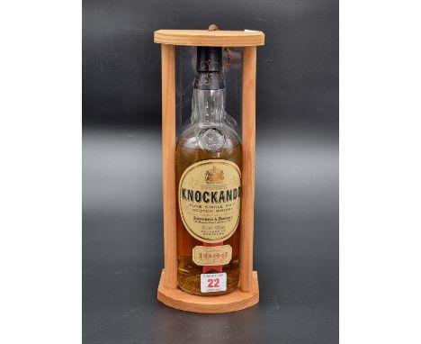 A 70cl bottle of Knockando 1986 Vintage Whisky, bottled in 1998, (some leakage) in pine stand.