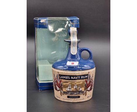 A 75cl bottle of Lamb's Navy Rum, in HMS Warrior pottery flagon, in card box.