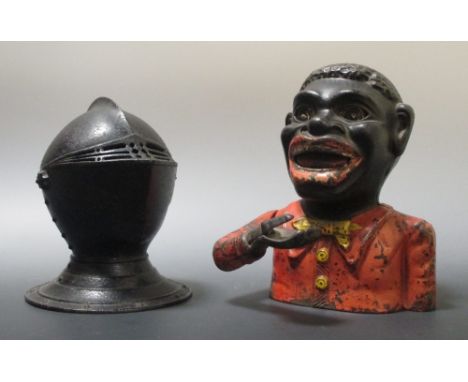 An early 20th century painted cast iron money bank and a desk top model helmet shaped inkwell with hinged top (2)  