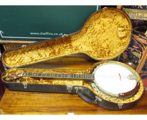 A Parker four string banjo, mother of pearl inlaid frets and birdseye maple body, cased  