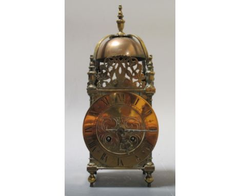 A late 19th century brass lantern clock and three brass faux jugs (4)  