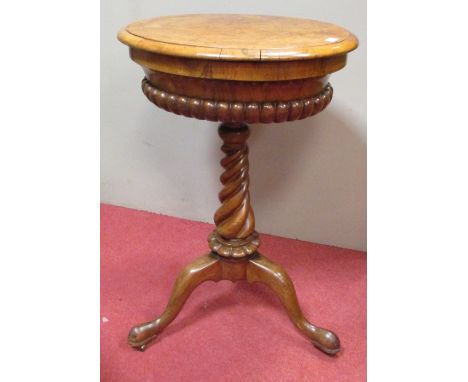 A mid Victorian burr walnut pedestal sewing table, the circular gadroon moulded top, on a tapering twist carved column and tr