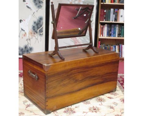 A brass mounted hardwood trunk with leather handles, possibly camphorwood, 102 x 50cm; and a mahogany toilet mirror (2)  